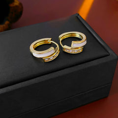 Gold huggie hoop earrings with ivory enamel arc and baguette CZ row — Luna Arc Enamel Baguette Huggies.