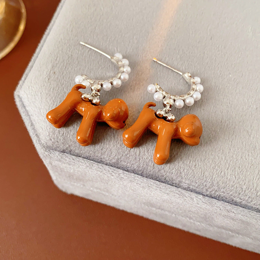 Pearl-adorned hoop earrings with dangling puppy charms in white and coffee — Pearl Pup Charm Hoops.