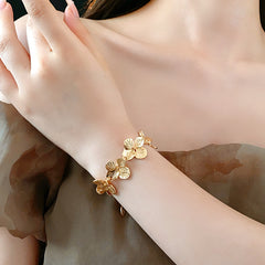 Golden Petal Elegance Set with necklace, bracelet, and earrings featuring golden floral petal details