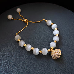 Gold-plated bracelet collection with pearls, cat’s eye stones, and floral motifs