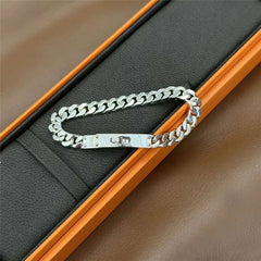 LockChain Minimalist Bracelet in silver, gold, and black metal chain with lock clasp design, displayed on wrist