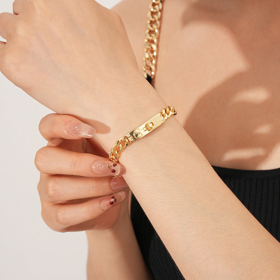 LockChain Minimalist Bracelet in silver, gold, and black metal chain with lock clasp design, displayed on wrist
