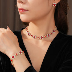 Crimson Heart Luxe Collection with red heart gemstone necklace, bracelet, and earrings, accented with pavé details