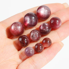 Lepidolite-in-Quartz crystal round beads with berry-pink striations, assorted 8–15 mm.