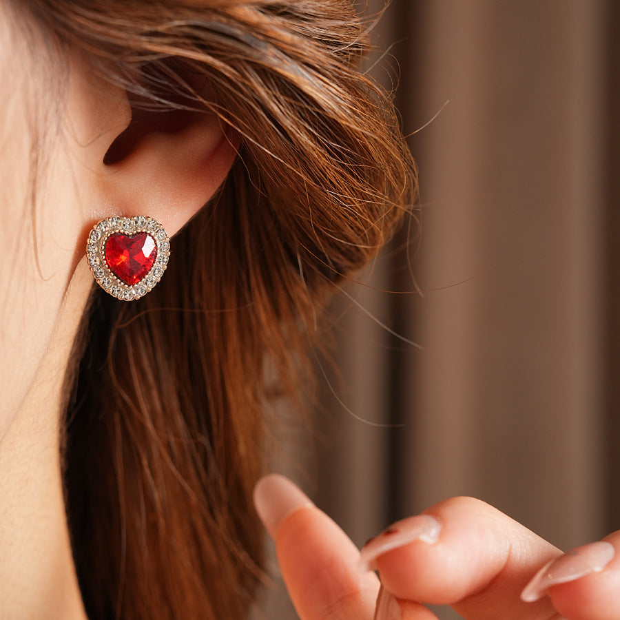 Crimson Heart Luxe Collection with red heart gemstone necklace, bracelet, and earrings, accented with pavé details