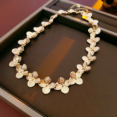 Golden Petal Elegance Set with necklace, bracelet, and earrings featuring golden floral petal details