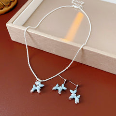 Silver-tone necklace and stud earrings with pastel blue balloon-dog charms — Blue Pup Pendant & Earrings Set.