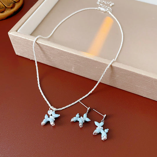 Silver-tone necklace and stud earrings with pastel blue balloon-dog charms — Blue Pup Pendant & Earrings Set.