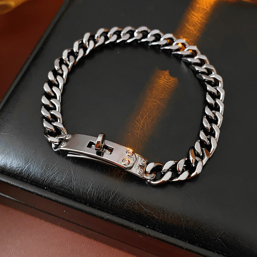 LockChain Minimalist Bracelet in silver, gold, and black metal chain with lock clasp design, displayed on wrist