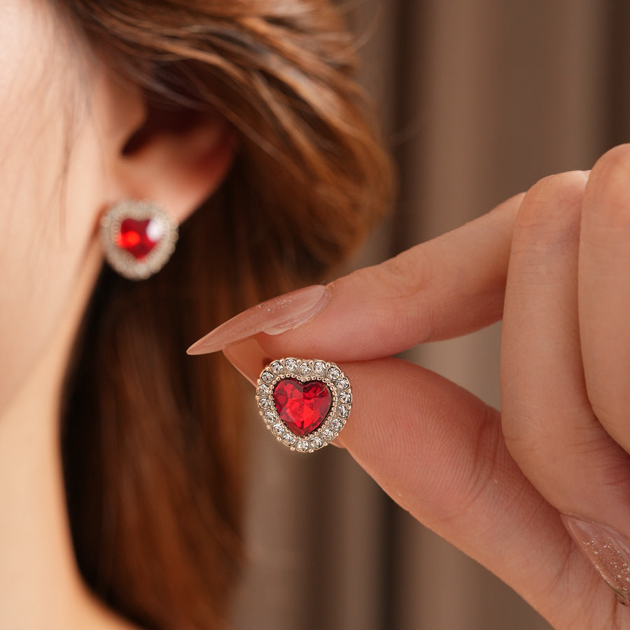 Crimson Heart Luxe Collection with red heart gemstone necklace, bracelet, and earrings, accented with pavé details