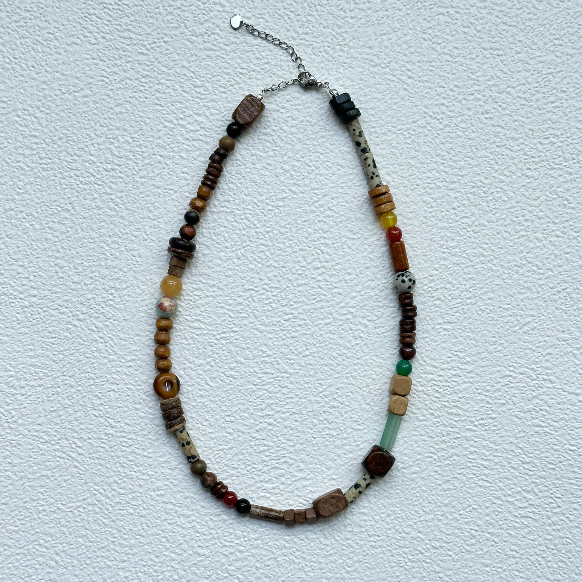 Full view of Desert Caravan Necklace hanging – warm desert palette with relaxed bohemian asymmetry
