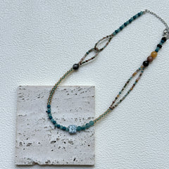 Full view of Aqua Loop Blossom Necklace hanging – handcrafted coastal palette of aqua and gold with asymmetrical loop detail