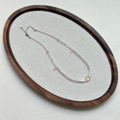 Blush Crystal Necklace oval flat lay – handmade blush and clear glass beaded necklace with minimalist crystal focal design by Glazenya