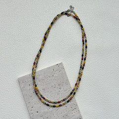 Tribal Glow Necklace close-up – handmade beaded necklace featuring red, yellow, green, and black glass beads by Glazenya