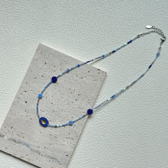 Handcrafted Celestial Wave Necklace laid flat showing silver, light blue, and dark blue beads