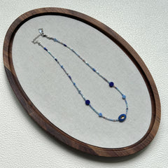 Handcrafted Celestial Wave Necklace laid flat showing silver, light blue, and dark blue beads2