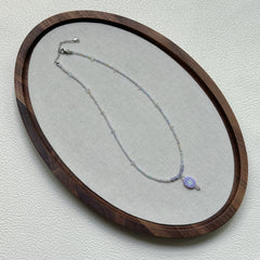 Handmade Aurora Dew Necklace laid flat, showing iridescent beads and delicate pendant details2