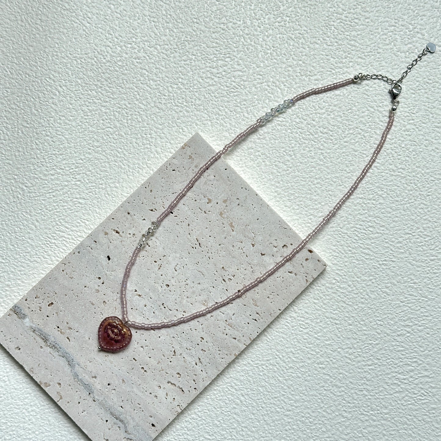 Close-up of Pink Serenade Necklace with heart-shaped pendant and blush beads