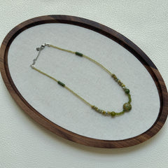 Green beaded luxury necklace on display stand