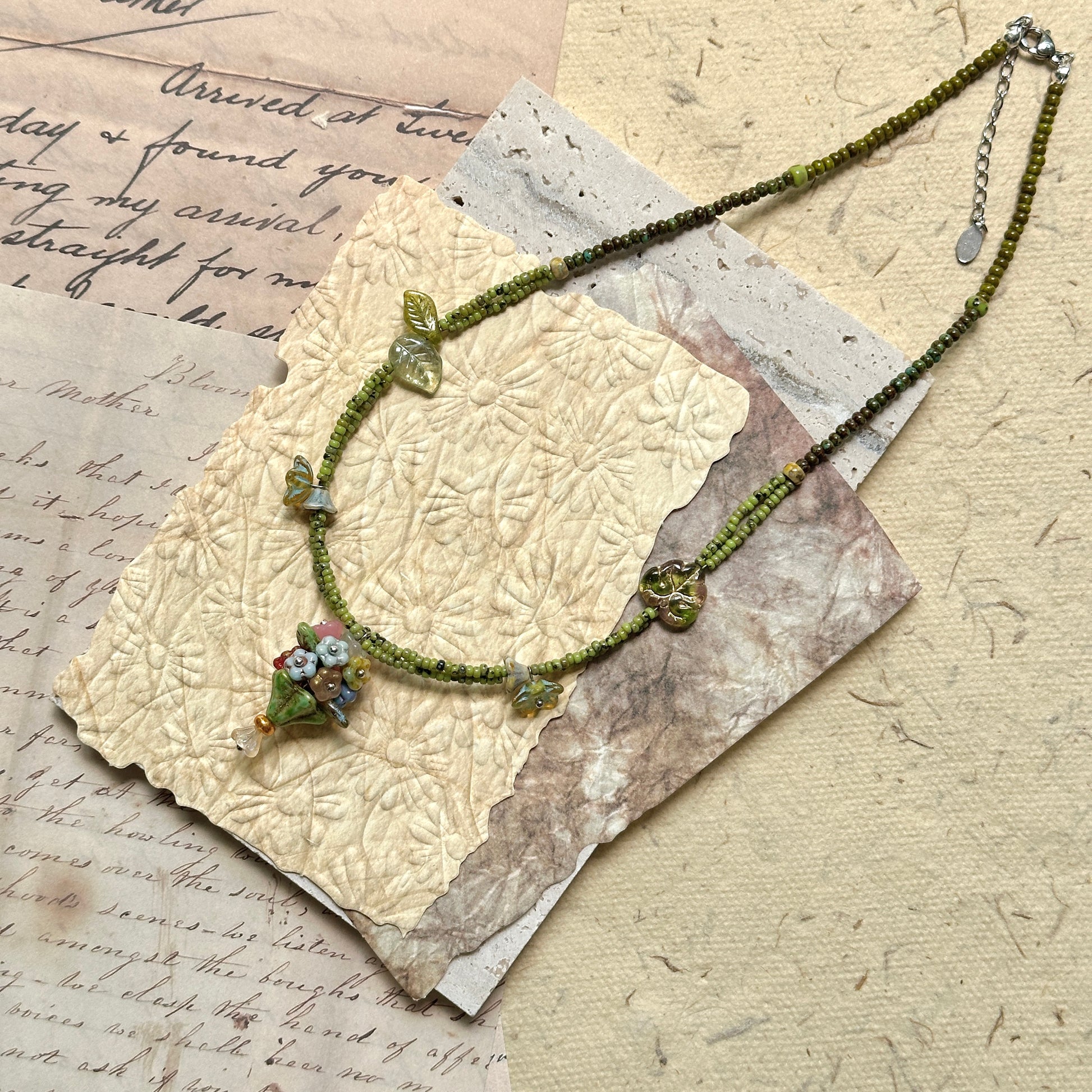 Green strand with Czech flower and butterfly details, garden-inspired