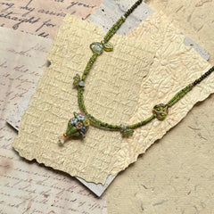 Model wearing Meadow Posy Charm Necklace, light floral style