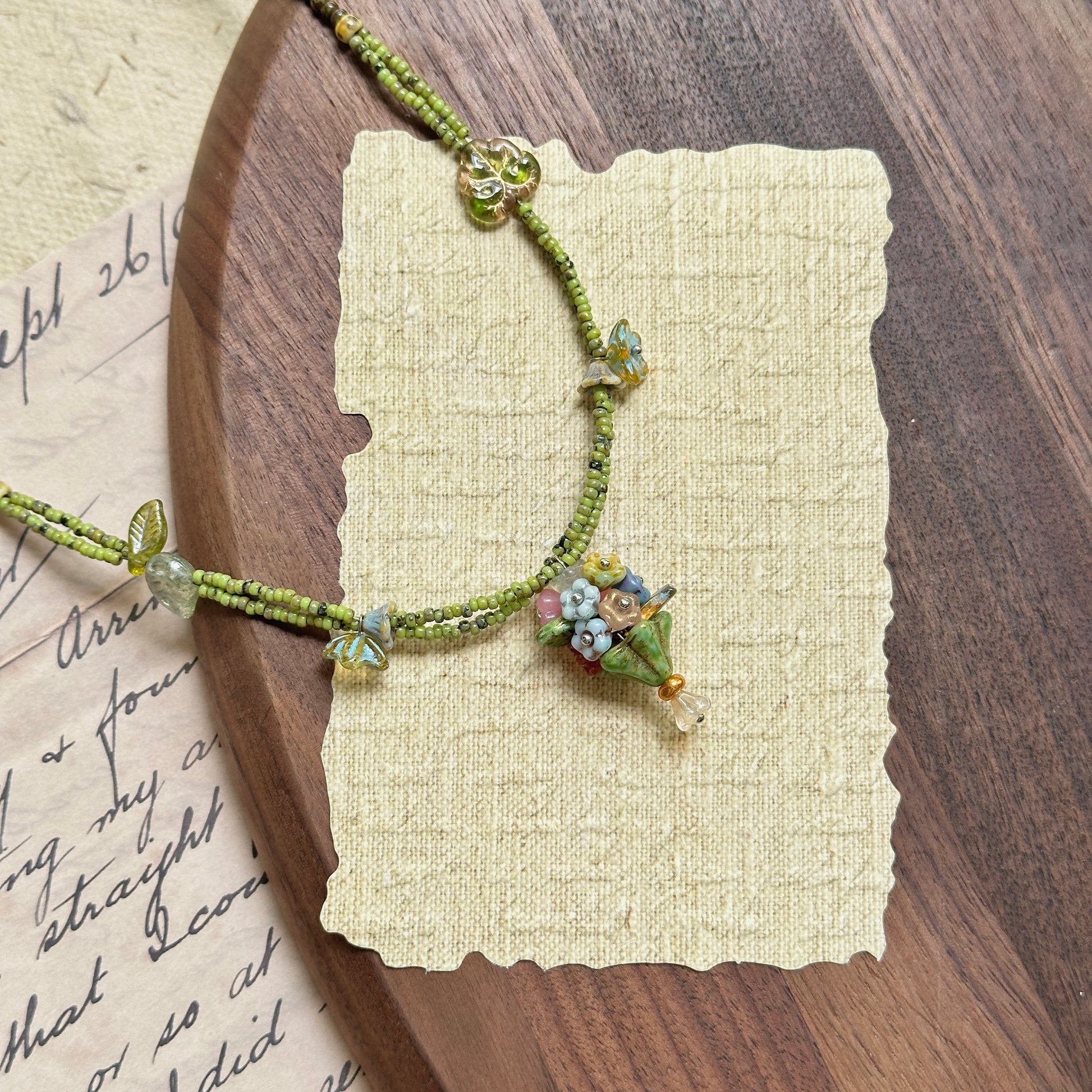 Handmade necklace with tiny bouquet (posy) charm, green seed beads and leaf accents – Glazenya