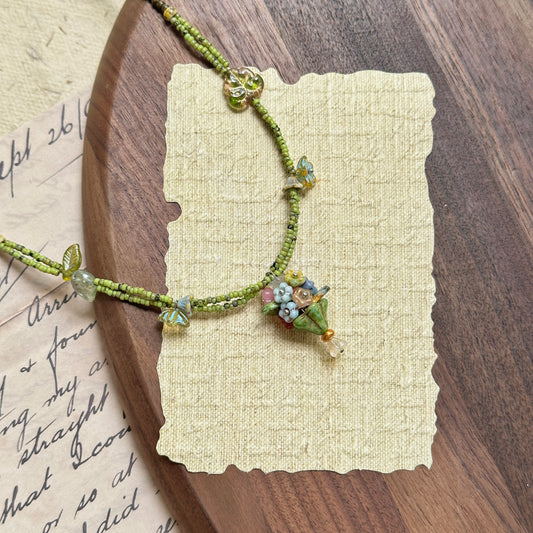 Handmade necklace with tiny bouquet (posy) charm, green seed beads and leaf accents – Glazenya