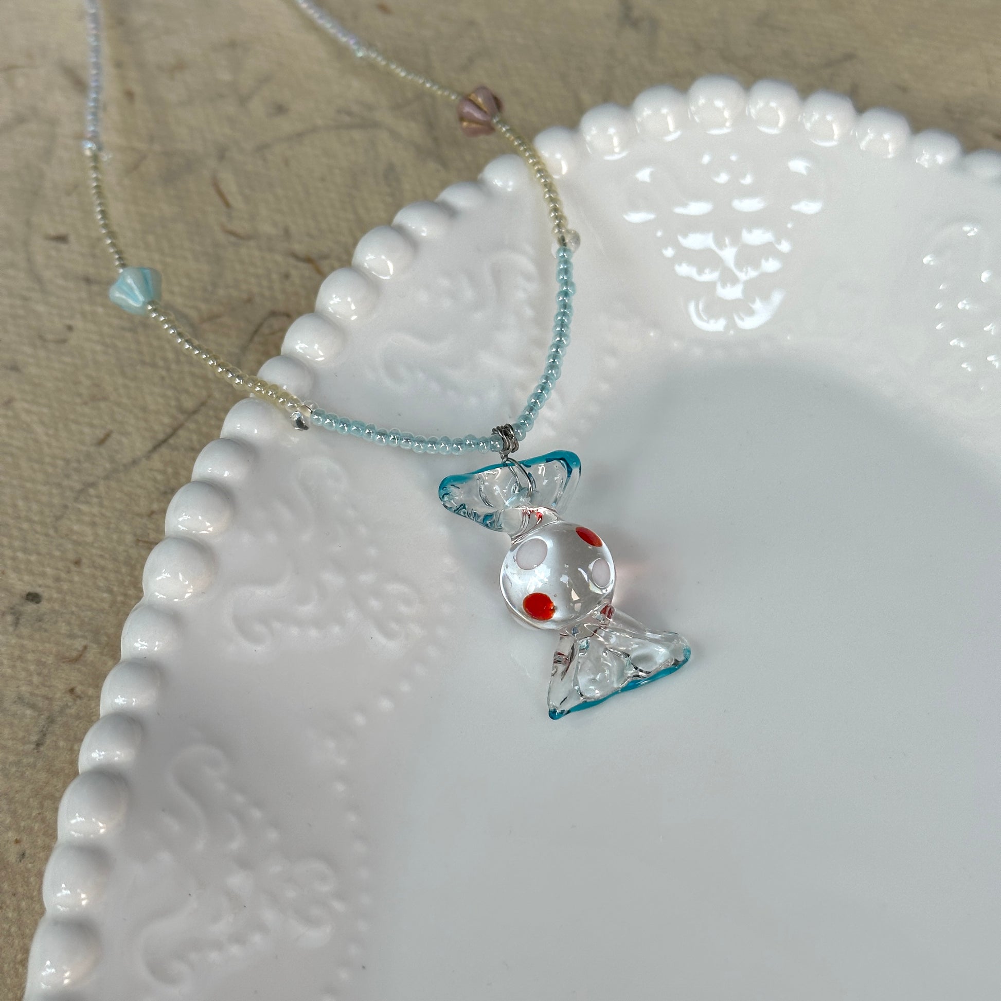Ocean Bonbon Necklace — close-up highlighting red-dot glass candy pendant and pastel beads