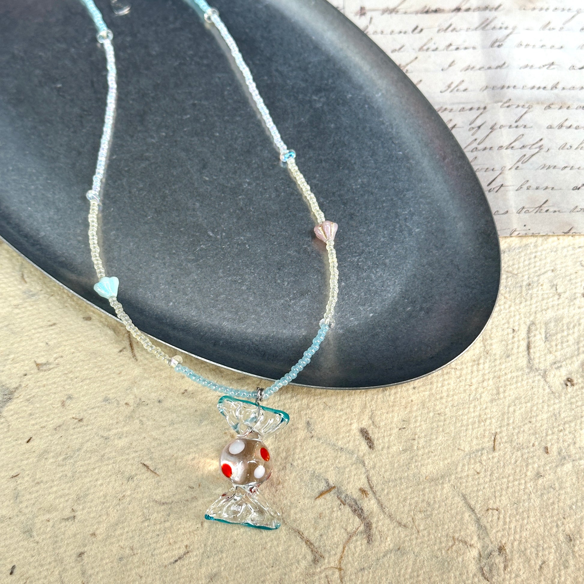 Ocean Bonbon Necklace — close-up highlighting red-dot glass candy pendant and pastel beads1