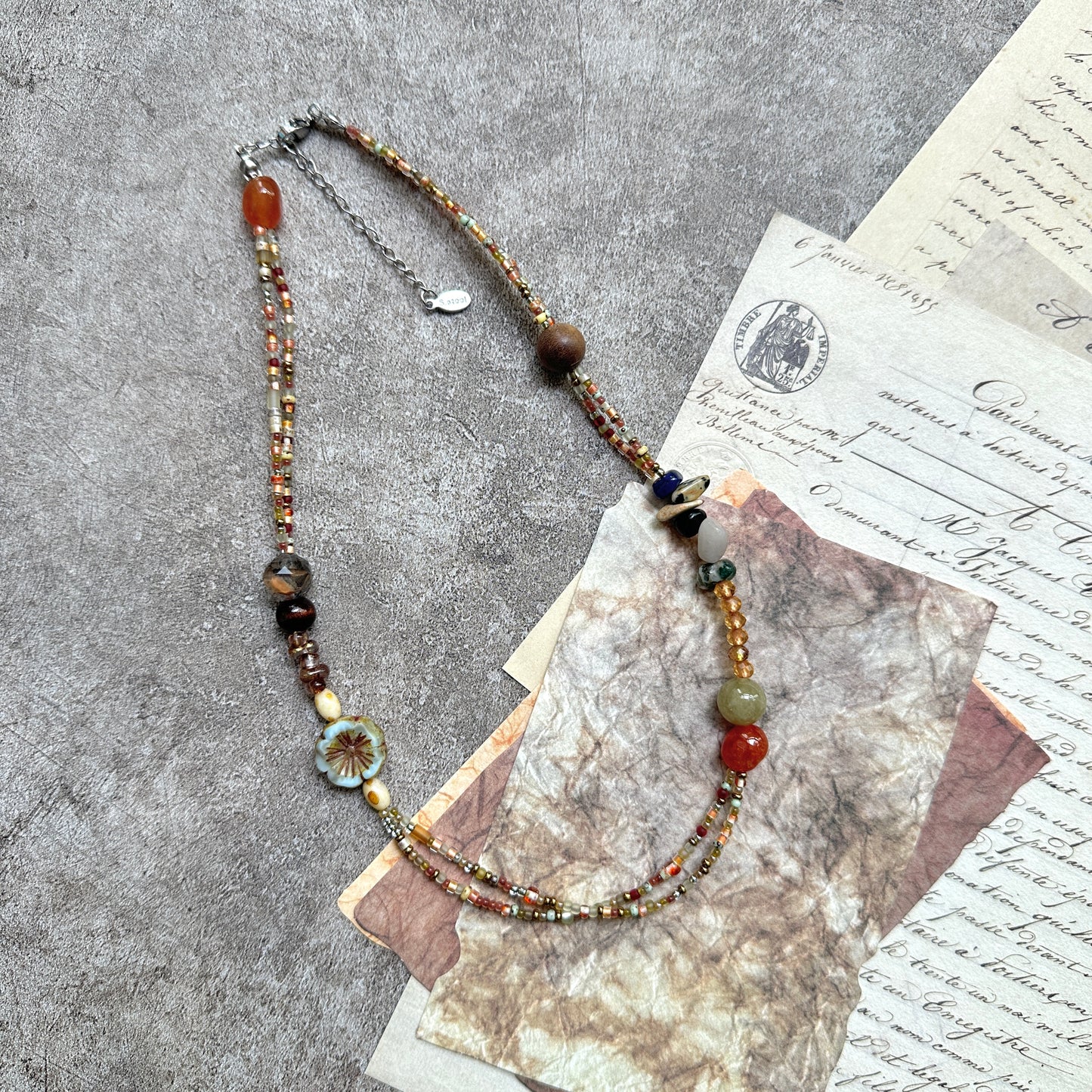 Marigold Mosaic Necklace — circle layout on neutral background showing asymmetric bead placement and floral coin detail