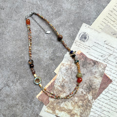 Marigold Mosaic Necklace — circle layout on neutral background showing asymmetric bead placement and floral coin detail