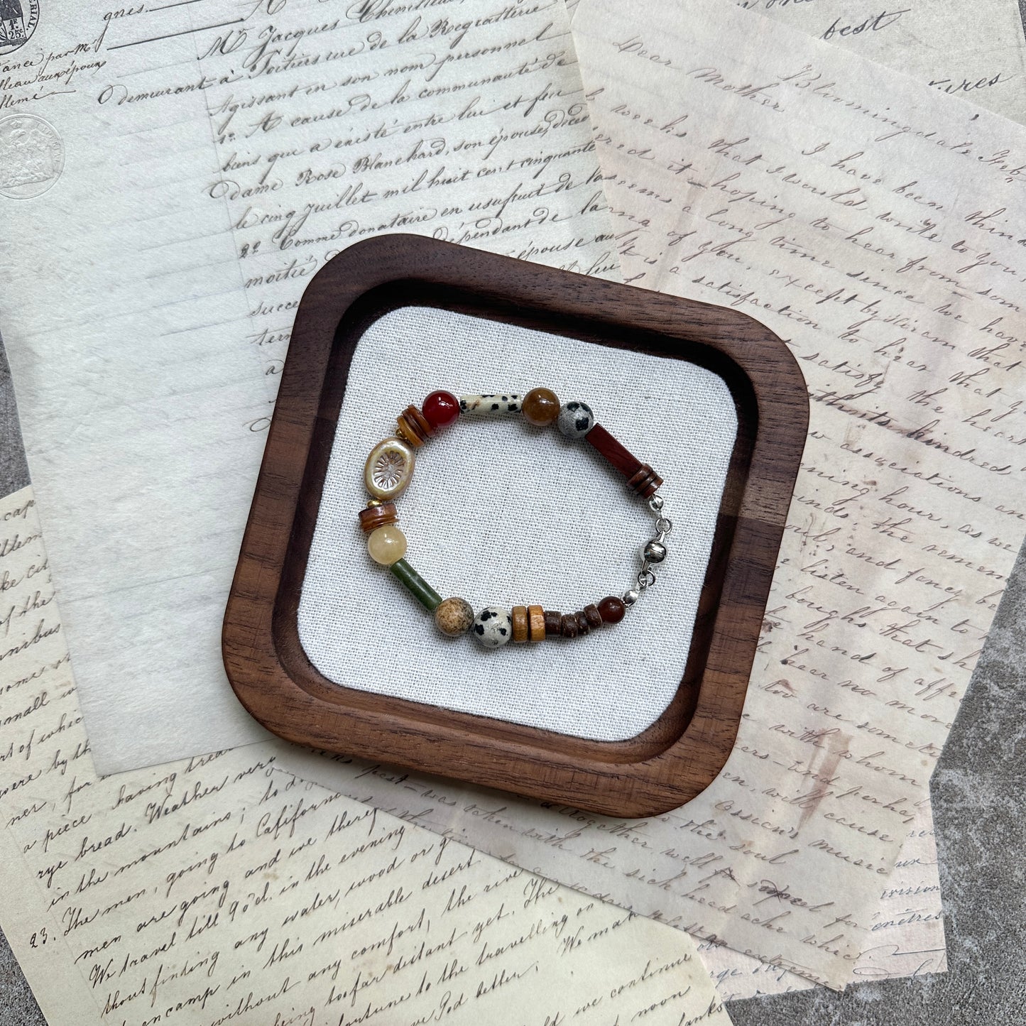 Spice Caravan Bracelet — circle layout on textured background showing warm saffron/amber palette and sunburst charm