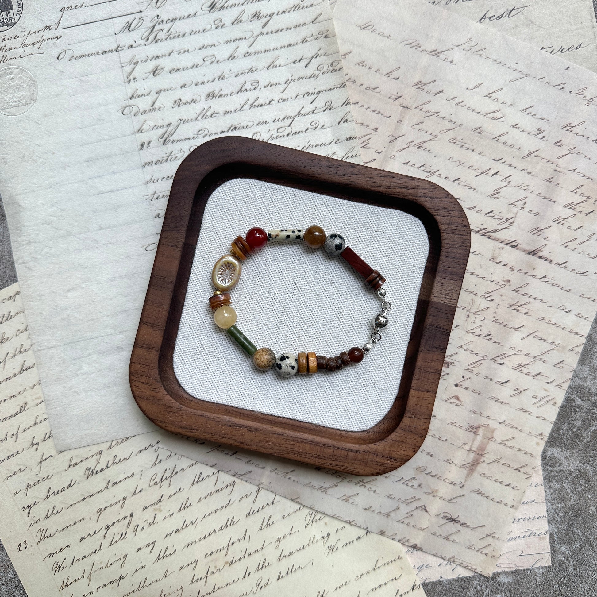 Spice Caravan Bracelet — circle layout on textured background showing warm saffron/amber palette and sunburst charm