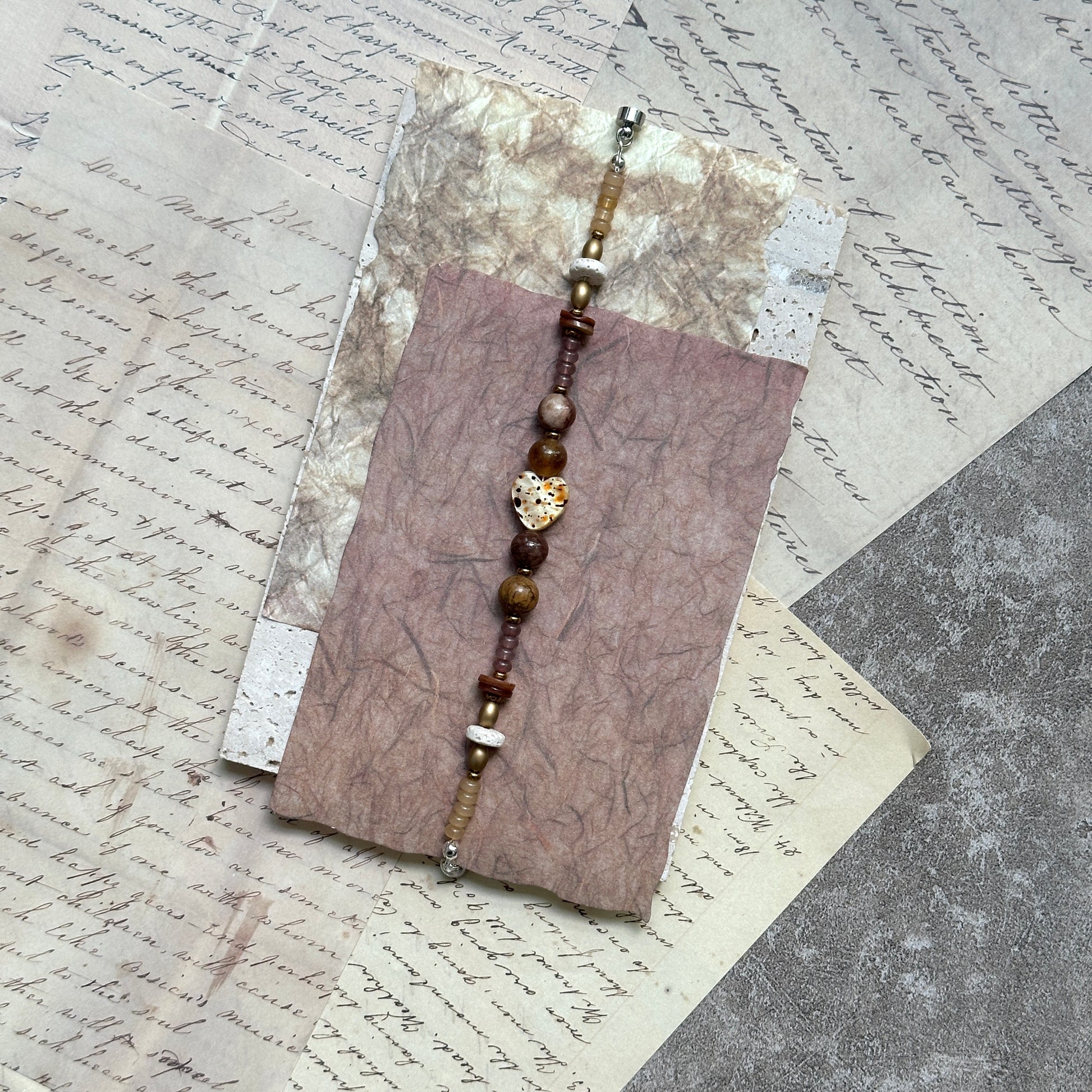 Speckled Honey Heart Bracelet — close-up highlighting the speckled heart bead, caramel tones, and magnetic clasp