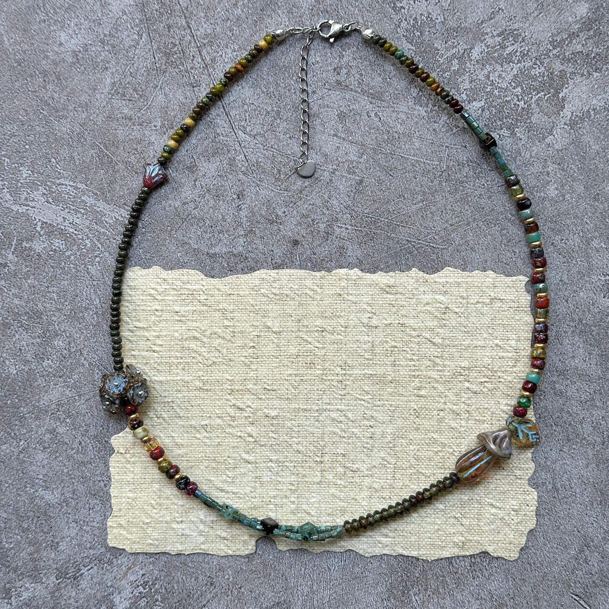 Garden palette strand in greens, ambers, and teal, lightweight handmade