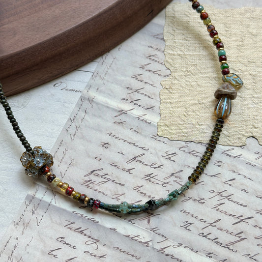 Handmade necklace with lampwork mushroom focal and moss-green/amber beads – Glazenya