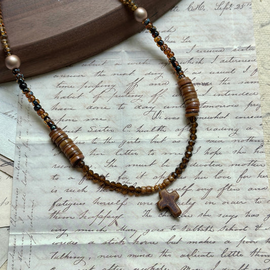 Amber Cross Necklace — close-up on neutral background; amber glass beads, pearl accent, small cross pendant