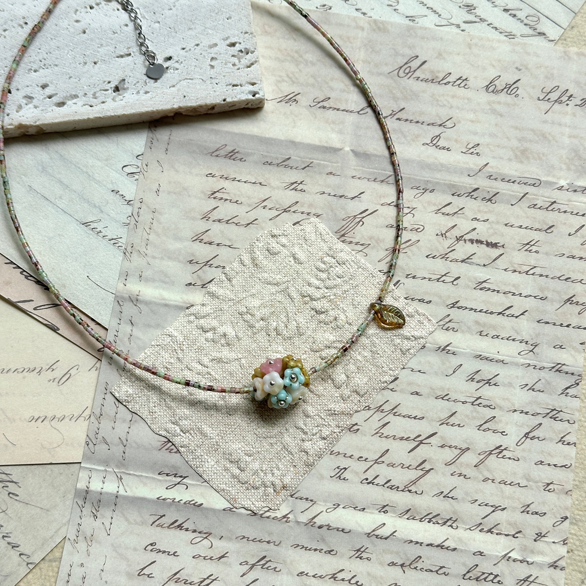 Blossom Garden Necklace — close-up of floral lampwork focal bead; multicolor seed beads detail