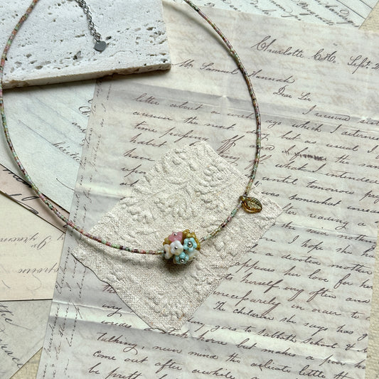 Blossom Garden Necklace — close-up of floral lampwork focal bead; multicolor seed beads detail