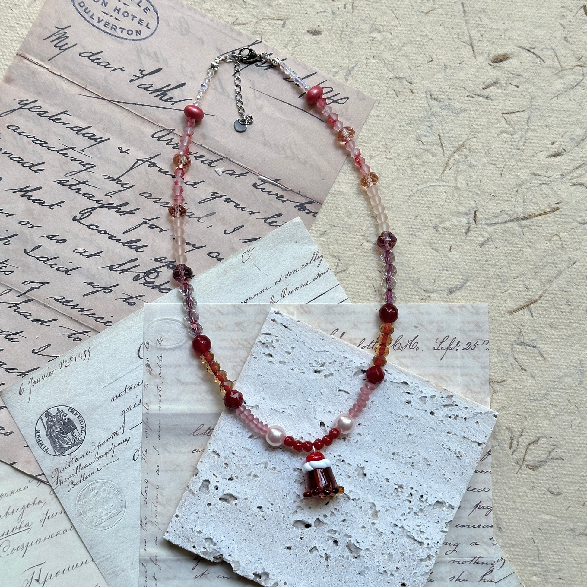 Blush and crimson glass bead strand with soft sparkle, handmade