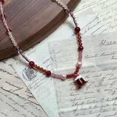Close-up of lampwork pudding-cup pendant with white swirl