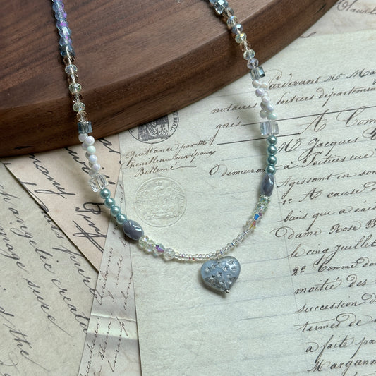Moonlit Heart Necklace — close-up of the heart-shaped centerpiece; crystal, pearl, and glass beads in soft icy blue