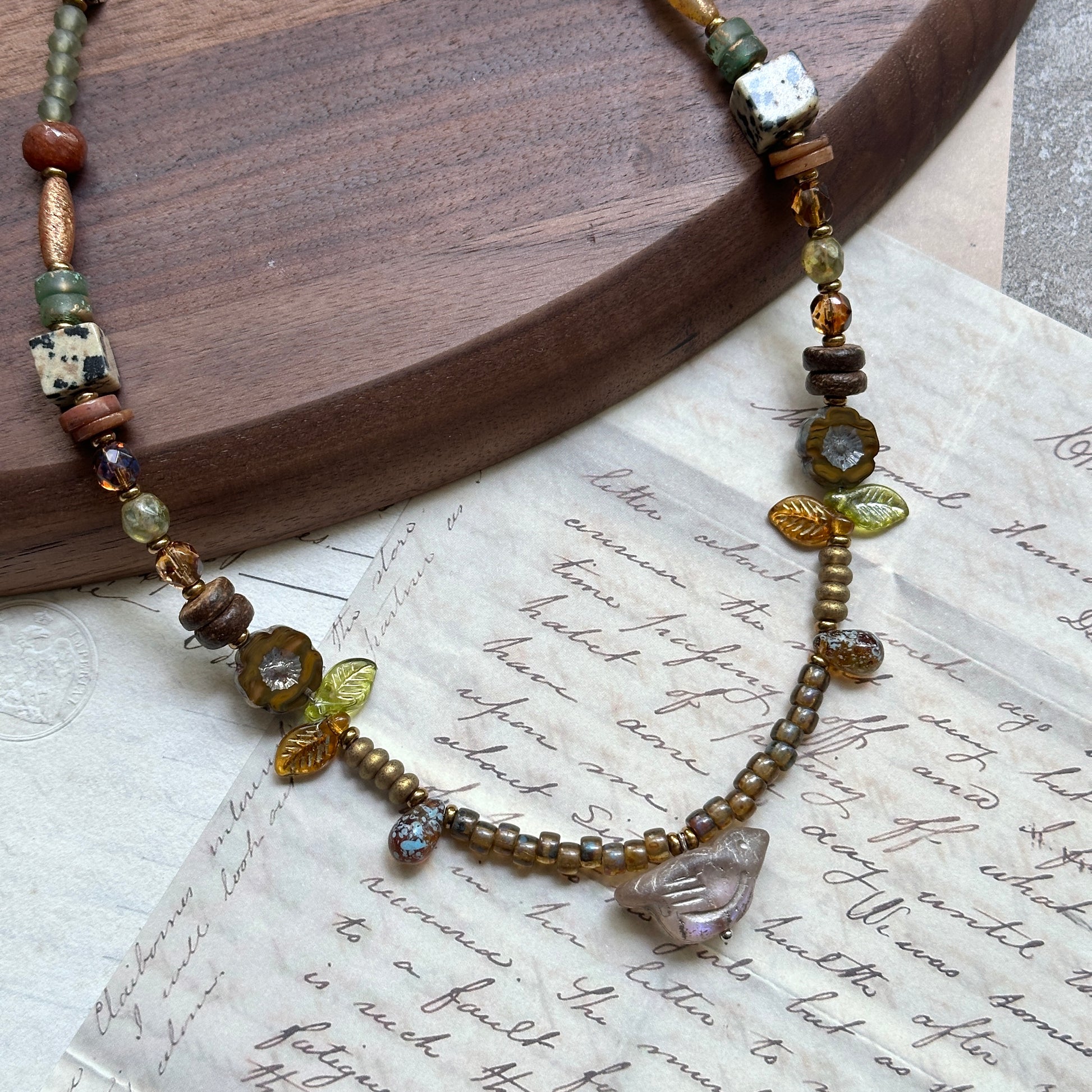 Amber Leaf Trail Necklace — circle layout highlighting glass leaf trail and clear chip focal