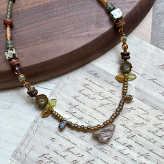 Amber Leaf Trail Necklace — circle layout highlighting glass leaf trail and clear chip focal