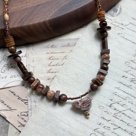 Handmade necklace with vintage lampwork bird pendant and warm amber–brown beads – Glazenya