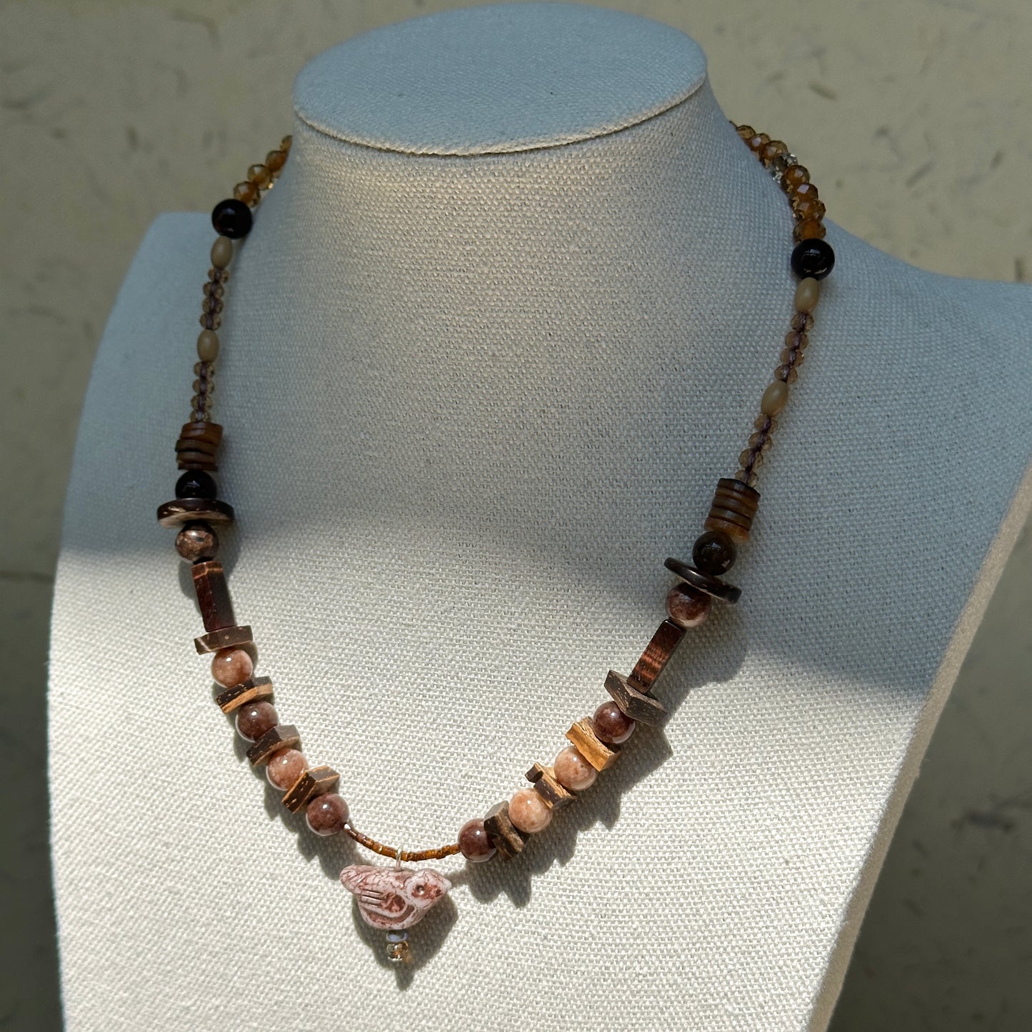 Model wearing Vintage Sparrow Charm Necklace, warm boho style