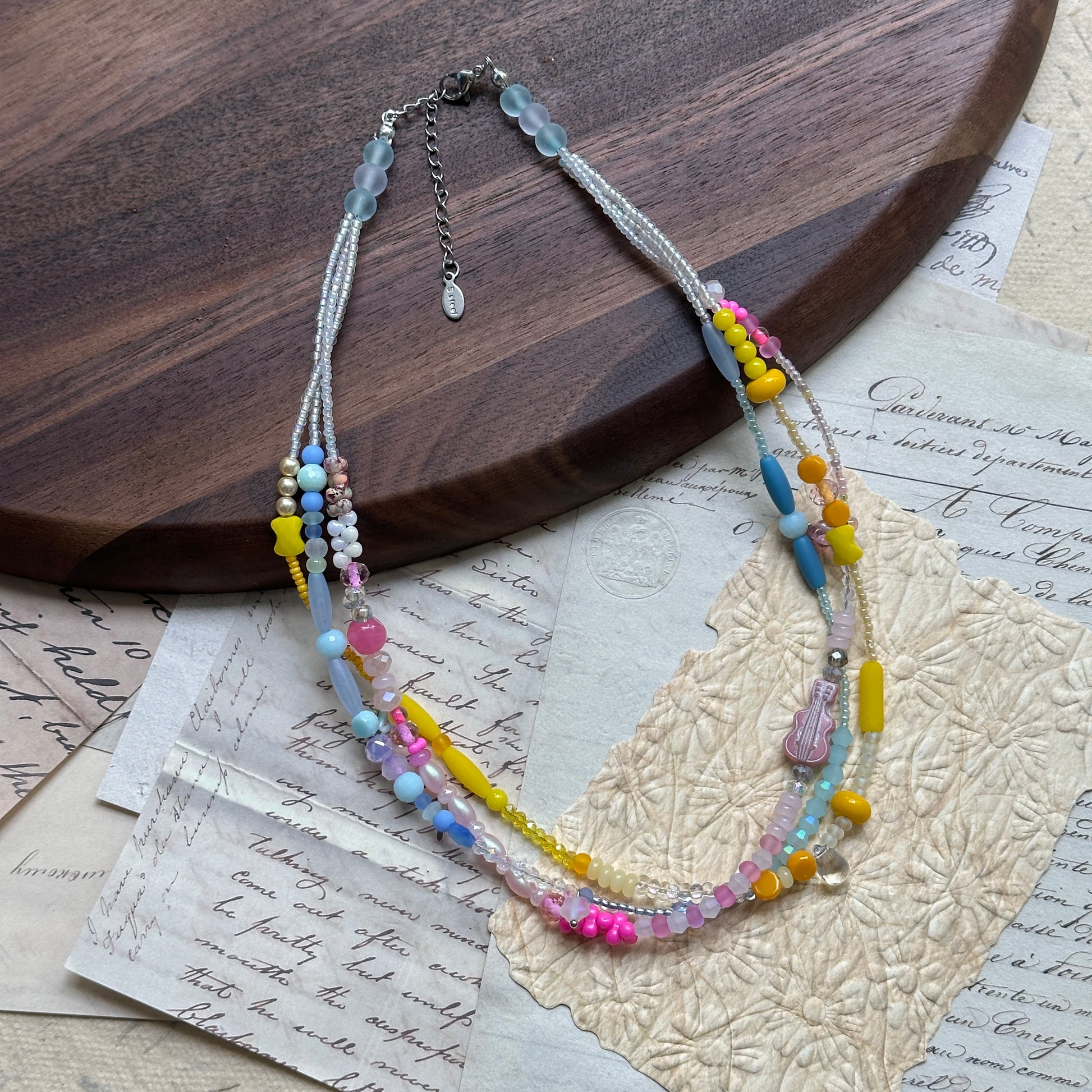 Sunshine Confetti Necklace flat lay with vibrant pastel palette, layered strands, and subtle crystal shimmer