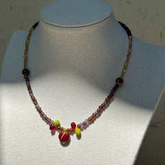 Model wearing Crimson Apple Charm Necklace, cozy evening palette