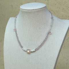 Blush Crystal Necklace worn on bust, highlighting square-cut crystal centerpiece with airy blush pink and white bead palette