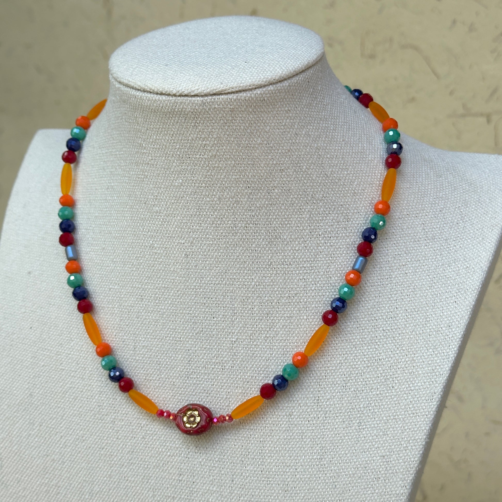Sunburst Fiesta Necklace worn on bust, highlighting colorful glass beads in a radiant, festival-inspired necklace design